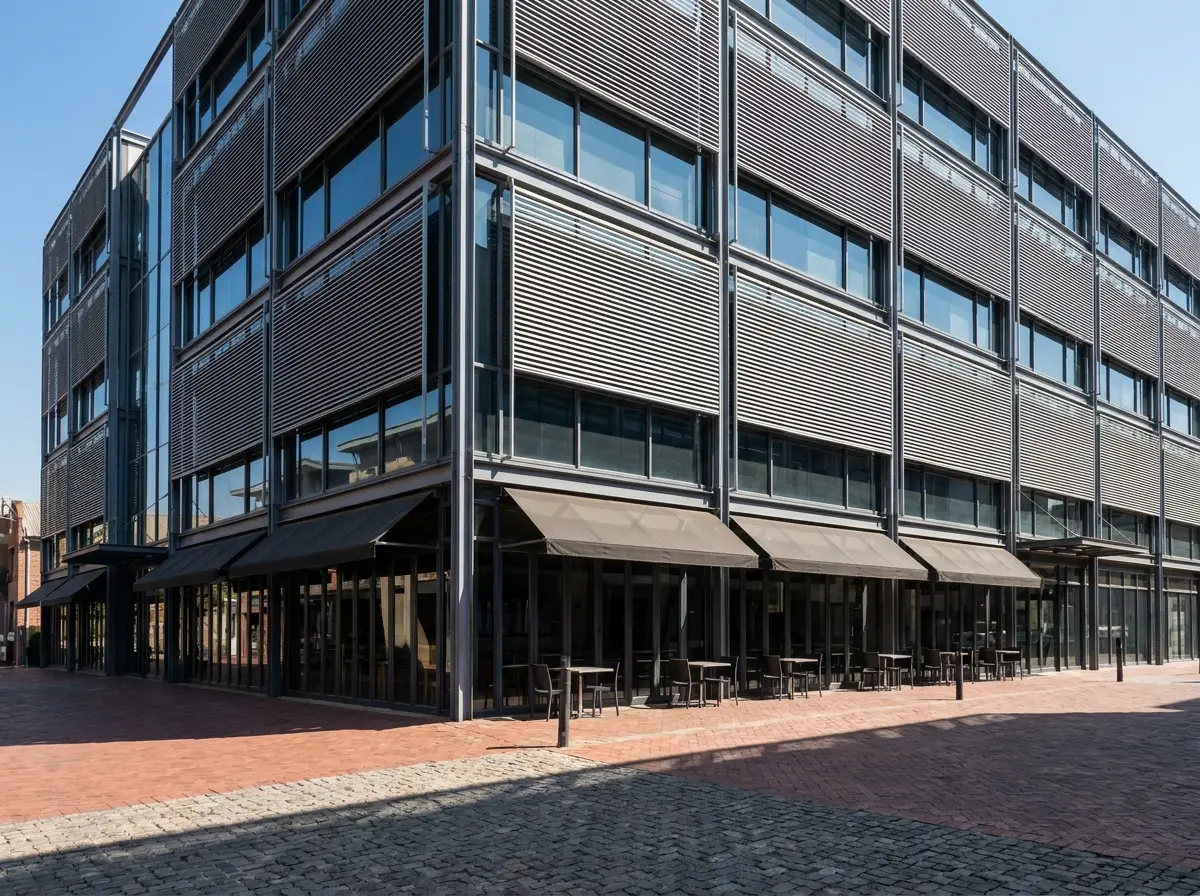 External aluminium venetian blinds shading a Melrose Arch office facade above the cobbled piazza